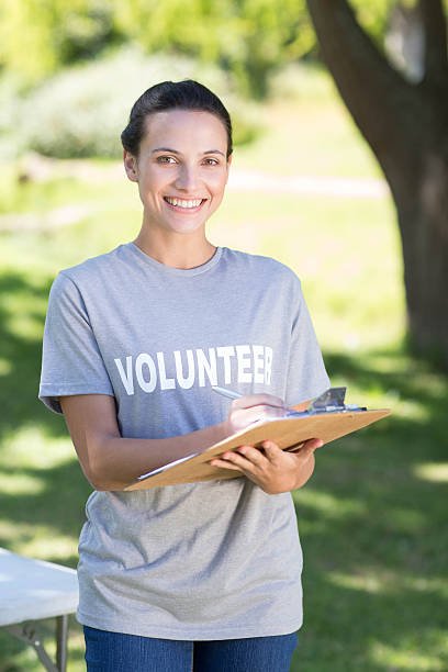 Happy volunteer in the park on a sunny day Get Involved